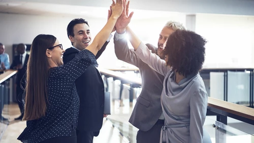 Cheerful office team giving high five